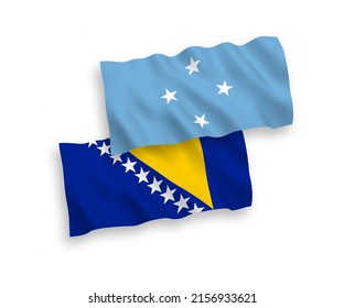 National vector fabric wave flags of Federated States of Micronesia and Bosnia and Herzegovina isolated on white background. 1 to 2 proportion.