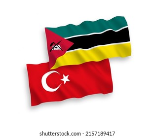 National vector fabric wave flags of Turkey and Republic of Mozambique isolated on white background. 1 to 2 proportion.