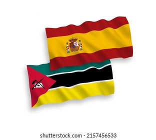 National vector fabric wave flags of Republic of Mozambique and Spain isolated on white background. 1 to 2 proportion.