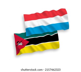 National vector fabric wave flags of Republic of Mozambique and Luxembourg isolated on white background. 1 to 2 proportion.
