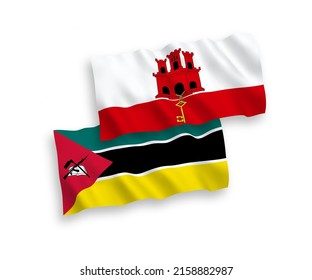 National vector fabric wave flags of Republic of Mozambique and Gibraltar isolated on white background. 1 to 2 proportion.
