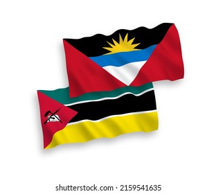 National vector fabric wave flags of Republic of Mozambique and Antigua and Barbuda isolated on white background. 1 to 2 proportion.