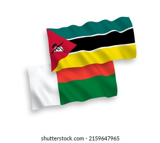National vector fabric wave flags of Republic of Mozambique and Madagascar isolated on white background. 1 to 2 proportion.