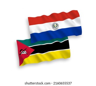 National vector fabric wave flags of Republic of Mozambique and Paraguay isolated on white background. 1 to 2 proportion.