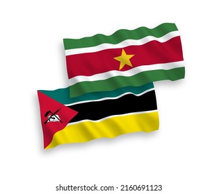 National vector fabric wave flags of Republic of Mozambique and Republic of Suriname isolated on white background. 1 to 2 proportion.