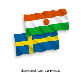 Banderas de olas de tela vectorial nacional de Suecia y la República del Níger aisladas en fondo blanco. de 1 a 2.