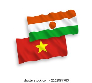 National vector fabric wave flags of Republic of the Niger and Vietnam isolated on white background. 1 to 2 proportion.