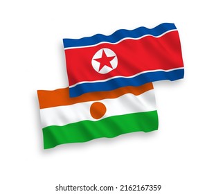 National vector fabric wave flags of North Korea and Republic of the Niger isolated on white background. 1 to 2 proportion.