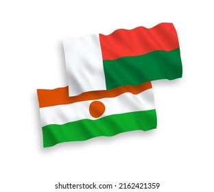 Nationale Vektor-Wellen-Flaggen der Republik Niger und Madagaskar einzeln auf weißem Hintergrund. 1 bis 2 %.