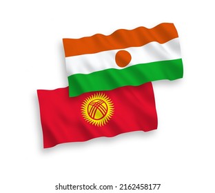 National vector fabric wave flags of Republic of the Niger and Kyrgyzstan isolated on white background. 1 to 2 proportion.
