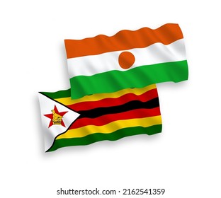 National vector fabric wave flags of Republic of the Niger and Zimbabwe isolated on white background. 1 to 2 proportion.