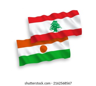 National vector fabric wave flags of Republic of the Niger and Lebanon isolated on white background. 1 to 2 proportion.