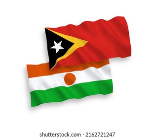 National vector fabric wave flags of Republic of the Niger and East Timor isolated on white background. 1 to 2 proportion.
