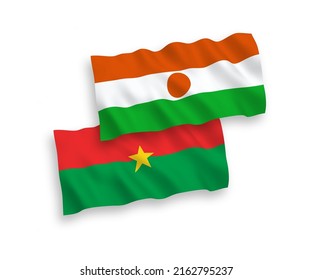 National vector fabric wave flags of Republic of the Niger and Burkina Faso isolated on white background. 1 to 2 proportion.