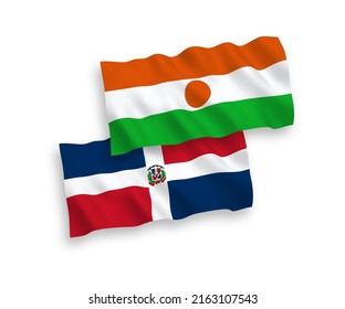National vector fabric wave flags of Republic of the Niger and Dominican Republic isolated on white background. 1 to 2 proportion.