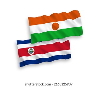 National vector fabric wave flags of Republic of the Niger and Republic of Costa Rica isolated on white background. 1 to 2 proportion.