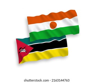 National vector fabric wave flags of Republic of the Niger and Republic of Mozambique isolated on white background. 1 to 2 proportion.