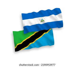 National vector fabric wave flags of Nicaragua and Tanzania isolated on white background. 1 to 2 proportion.