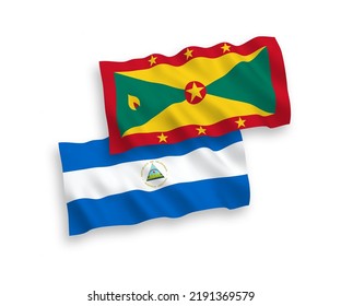 National vector fabric wave flags of Nicaragua and Grenada isolated on white background. 1 to 2 proportion.
