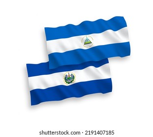 National vector fabric wave flags of Nicaragua and Republic of El Salvador isolated on white background. 1 to 2 proportion.