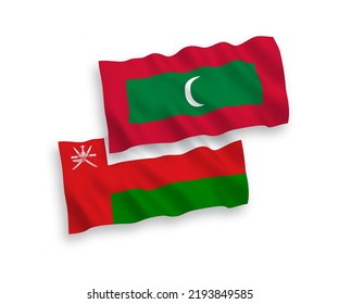 National vector fabric wave flags of Sultanate of Oman and Maldives isolated on white background. 1 to 2 proportion.