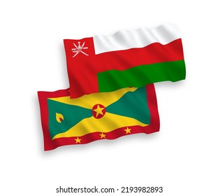 National vector fabric wave flags of Sultanate of Oman and Grenada isolated on white background. 1 to 2 proportion.