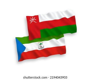 National vector fabric wave flags of Sultanate of Oman and Republic of Equatorial Guinea isolated on white background. 1 to 2 proportion.