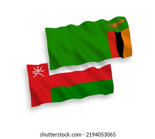 National vector fabric wave flags of Sultanate of Oman and Republic of Zambia isolated on white background. 1 to 2 proportion.