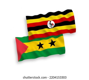 National vector fabric wave flags of Saint Thomas and Prince and Uganda isolated on white background. 1 to 2 proportion.
