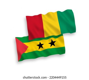 National vector fabric wave flags of Saint Thomas and Prince and Guinea isolated on white background. 1 to 2 proportion.