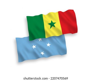 National vector fabric wave flags of Republic of Senegal and Federated States of Micronesia isolated on white background. 1 to 2 proportion.