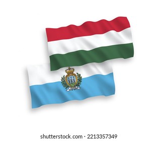National vector fabric wave flags of San Marino and Hungary isolated on white background. 1 to 2 proportion.