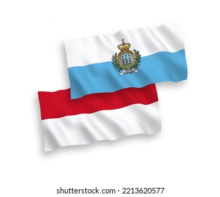 National vector fabric wave flags of Indonesia and San Marino isolated on white background. 1 to 2 proportion.
