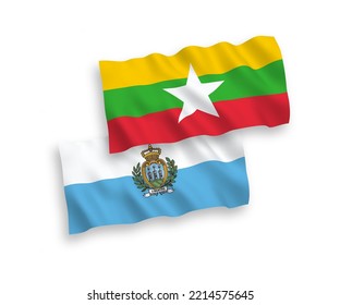 National vector fabric wave flags of San Marino and Myanmar isolated on white background. 1 to 2 proportion.