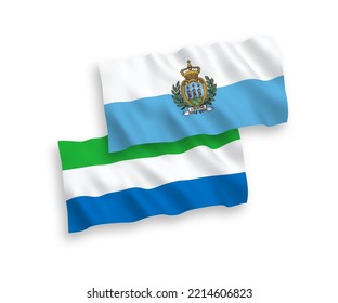 National vector fabric wave flags of San Marino and Sierra Leone isolated on white background. 1 to 2 proportion.