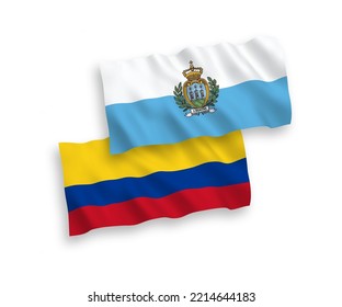 National vector fabric wave flags of San Marino and Colombia isolated on white background. 1 to 2 proportion.