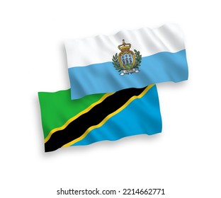 National vector fabric wave flags of San Marino and Tanzania isolated on white background. 1 to 2 proportion.