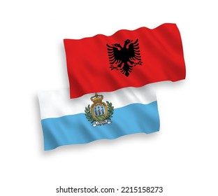 National vector fabric wave flags of San Marino and Albania isolated on white background. 1 to 2 proportion.