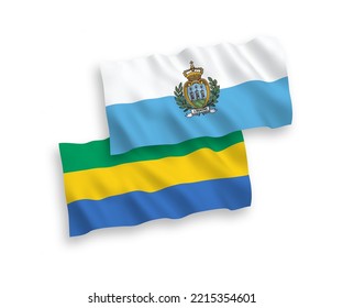 National vector fabric wave flags of San Marino and Gabon isolated on white background. 1 to 2 proportion.