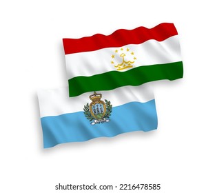 National vector fabric wave flags of San Marino and Tajikistan isolated on white background. 1 to 2 proportion.