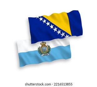 National vector fabric wave flags of San Marino and Bosnia and Herzegovina isolated on white background. 1 to 2 proportion.