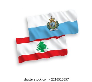 National vector fabric wave flags of San Marino and Lebanon isolated on white background. 1 to 2 proportion.