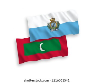 National vector fabric wave flags of San Marino and Maldives isolated on white background. 1 to 2 proportion.