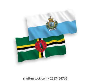 National vector fabric wave flags of San Marino and Dominica isolated on white background. 1 to 2 proportion.