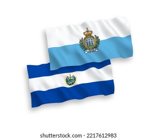 National vector fabric wave flags of San Marino and Republic of El Salvador isolated on white background. 1 to 2 proportion.