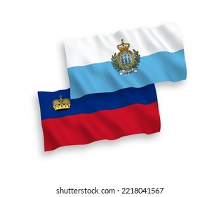 National vector fabric wave flags of San Marino and Liechtenstein isolated on white background. 1 to 2 proportion.