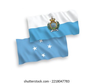 National vector fabric wave flags of San Marino and Federated States of Micronesia isolated on white background. 1 to 2 proportion.