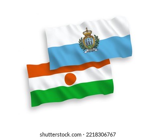 National vector fabric wave flags of San Marino and Republic of the Niger isolated on white background. 1 to 2 proportion.