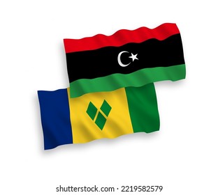 National vector fabric wave flags of Saint Vincent and the Grenadines and Libya isolated on white background. 1 to 2 proportion.