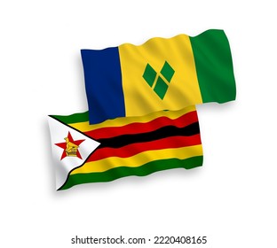 National vector fabric wave flags of Saint Vincent and the Grenadines and Zimbabwe isolated on white background. 1 to 2 proportion.